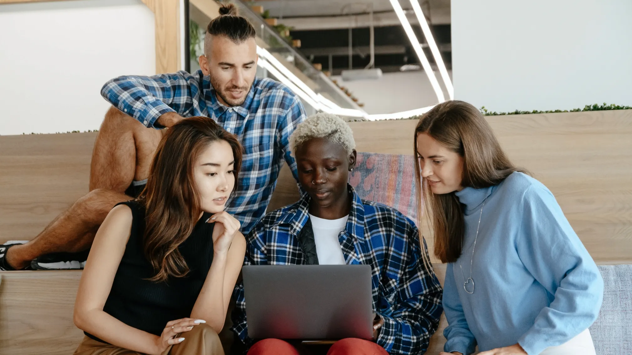 Colleagues gathered around a laptop